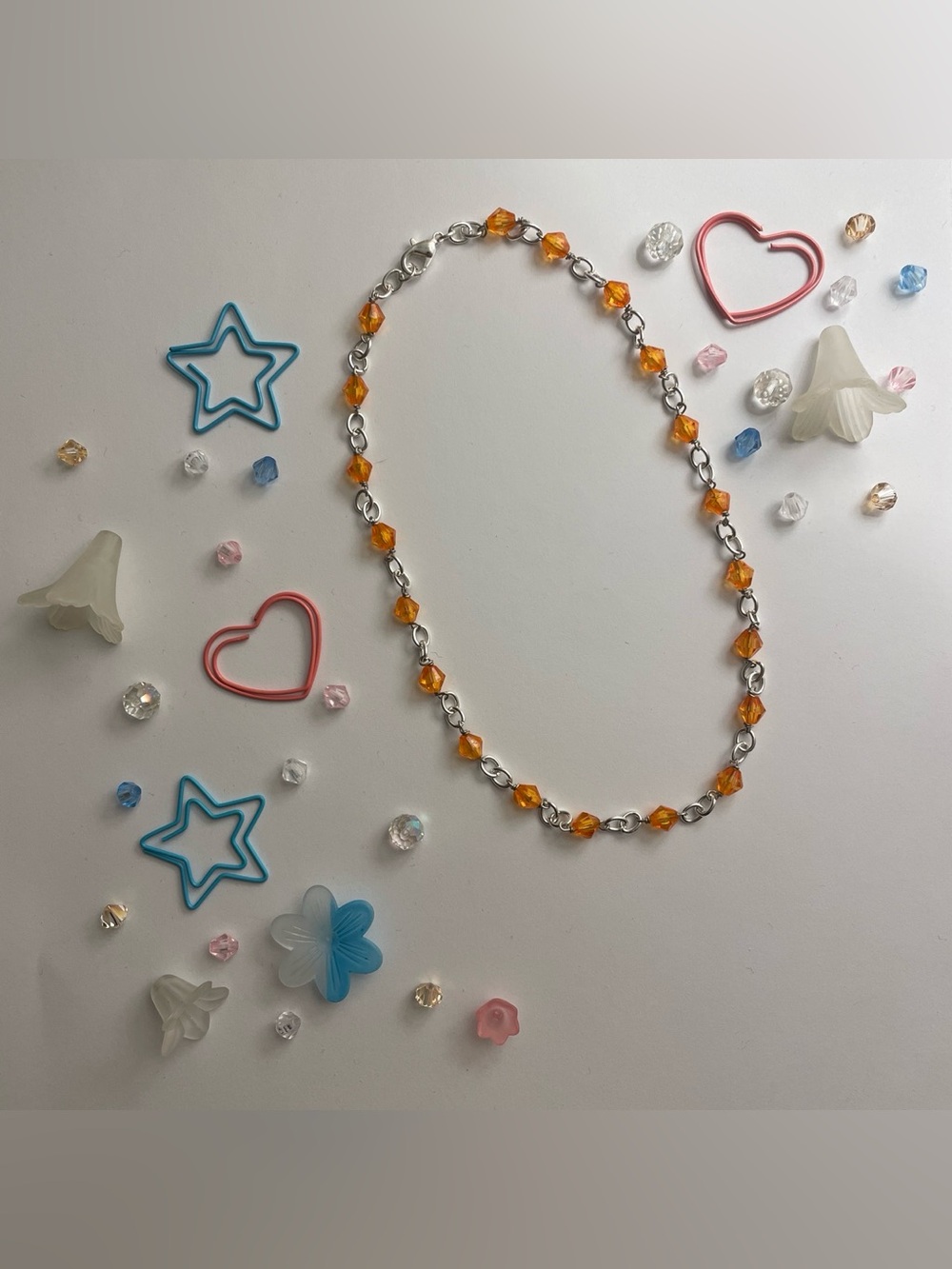 Silver chain necklace with orange beads